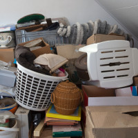 Pile of junk in a house, hoarder room pile of household equipment needs clearing out storage